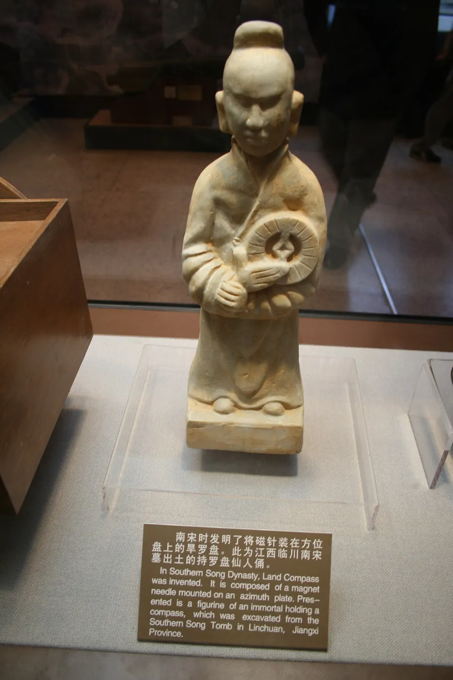 Figura de la dinastía Song sosteniendo una brújula de placa